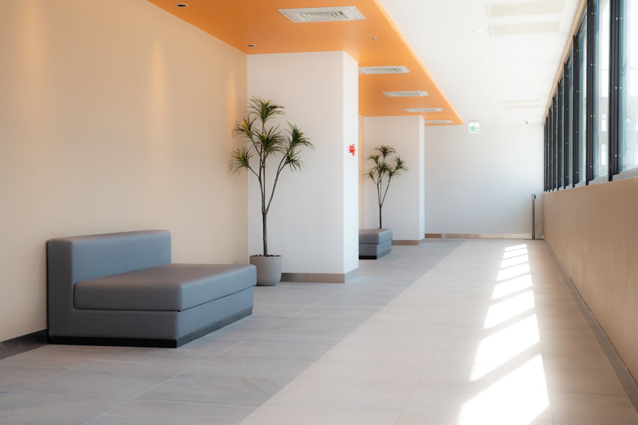 about-01 A bright, modern hallway in a Taiwanese building featuring minimalist seating and natural light.